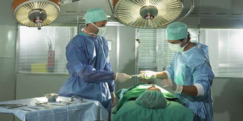 Two male surgeons  performing surgery