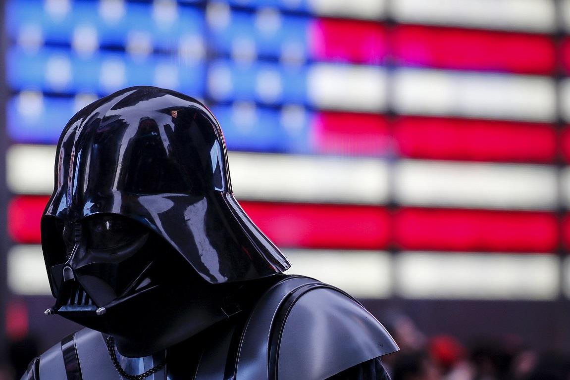 A man dressed as Darth Vader from Star Wars walks though Times Square during unseasonably warm weather on Christmas eve in Manhattan
