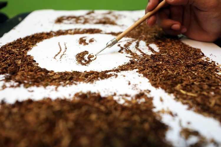 Artist Abdelrahman al-Habrouk creates a portrait of the Egyptian actor Adel Imam with tobacco in Alexandria