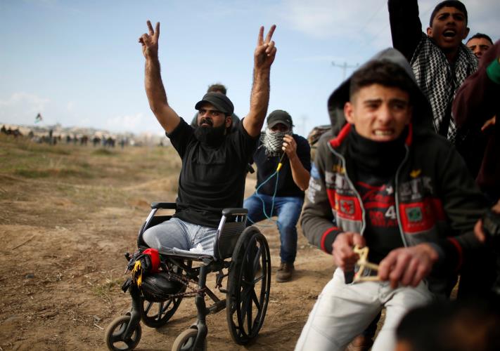 Wheelchair-bound Palestinian demonstrator Ibraheem Abu Thuraya, who according to medics was killed later on Friday during clashes with Israeli troops, gestures during a protest, near the border with Israel in the east of Gaza City