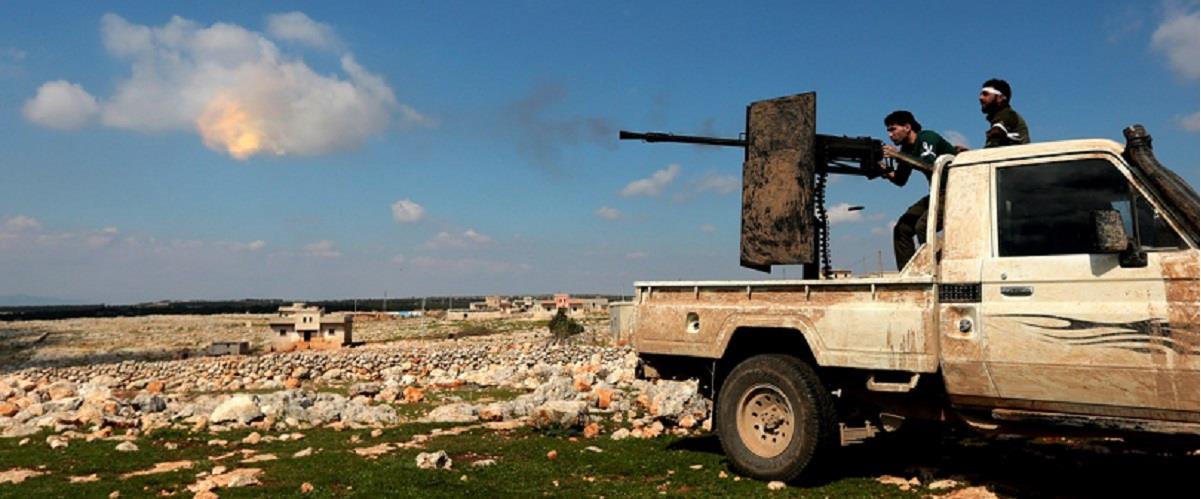 epaselect epa06600956 Turkey-backed Free Syrian Army soldiers shoot with heavy machine gun during an offensive, at Der Mismis Village, southeast of Afrin, Syria, 13 March 2018. According to media reports, the Turkish army and its allied Syrian militias on 10 March continued to encircle the city of Afrin in the Kurdish-held enclave of the same name in northwest Syrian, taking control of nine towns. The Turkish army on 20 January launched 'Operation Olive Branch' in Syria's northern regions against the Kurdish Popular Protection Units (YPG) forces and the Syrian Democratic Forces (SDF) which control the city of Afrin. Turkey classifies the YPG as a terrorist organization. The Turkish-backed Free Syrian Army is an armed rebel military group that operates in northern Syria and is supported by the Turkish army.  EPA/STR
