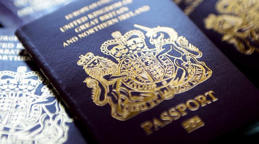 epa04253524 British passports in London, Britain, 13 June 2014. The Home Office has said on 12 July that to help clear the huge backlog of passport applications it will scrap charges for urgent renewals. Some 30,000 people have been impacted by the delays.  EPA/ANDY RAIN
