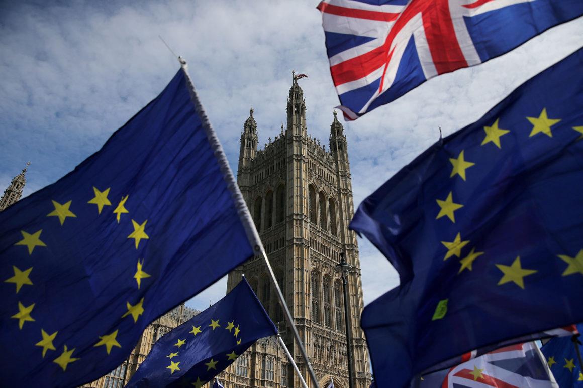Pro-EU demonstrators wave Eureopean Union and Union flags during a protest against Brexit, outside of the Houses of Parliament in central London on June 11, 2018. - After a rollercoaster week of Brexit rows within her government and with Brussels, British Prime Minister Theresa May will on Tuesday seek to avoid another setback in a long-awaited showdown with parliament. MPs in the House of Commons will vote on a string of amendments to a key piece of Brexit legislation that could force the government's hand in the negotiations with the European Union. (Photo by Daniel LEAL-OLIVAS / AFP) (Photo credit should read DANIEL LEAL-OLIVAS/AFP/Getty Images)