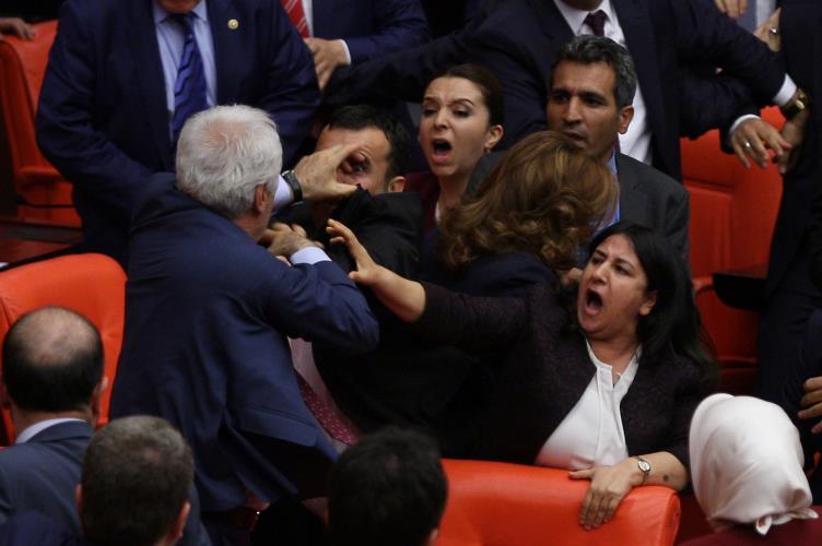 Ruling AK Party and pro-Kurdish Peoples' Democratic Party (HDP) lawmakers scuffle during a debate at the Parliament in Ankara