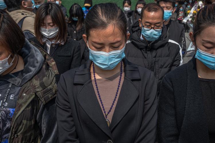 People observe three minutes of silence for victims of COVID-19, in China