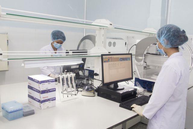 Employees of Viet A corp work inside a lab of their factory in Binh Duong province