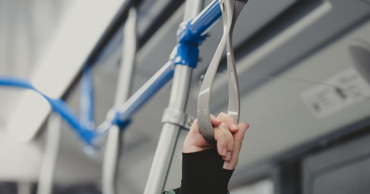 the-hand-of-a-woman-holding-on-to-the-handrail-fro-2023-11-27-05-29-26-utc