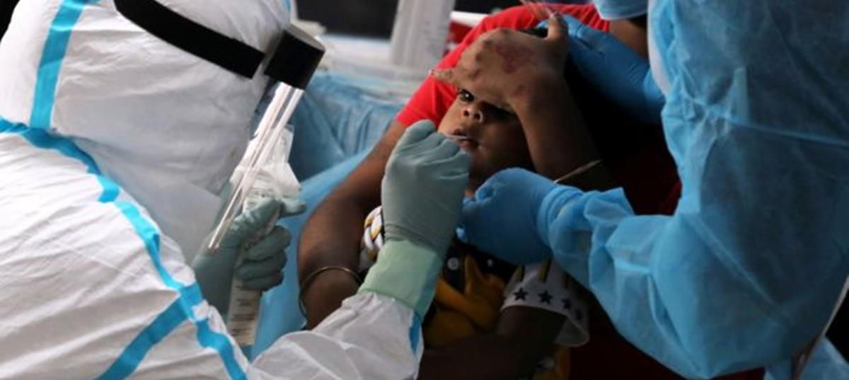 Medical worker collects a swab sample from a child to be tested for the coronavirus in Petaling Jaya