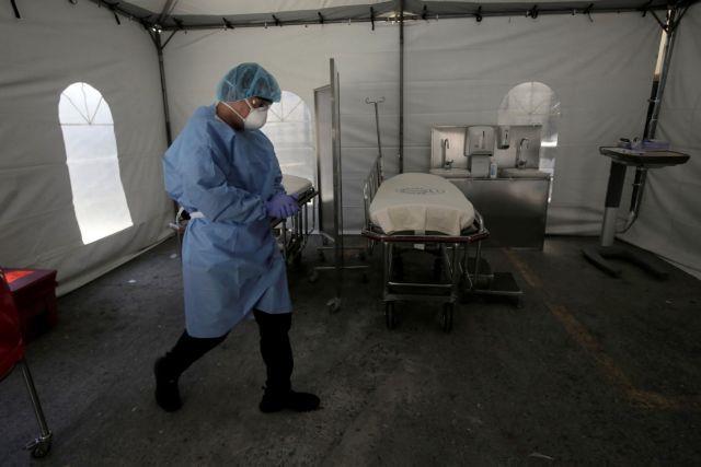 A member of the medical personnel wearing a protective face mask is seen at a tent triage prepared for the suspected coronavirus patients in San Jose
