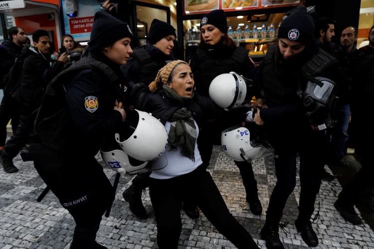 Riot police detain a demonstrator during a protest against Turkey's military operation in Syria's Afrin region, in Istanbul